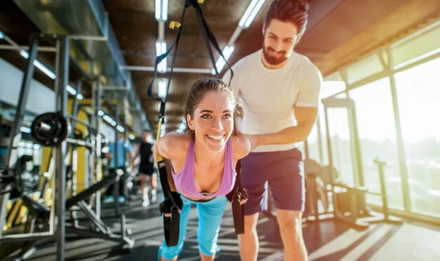 Personal trainer helping client